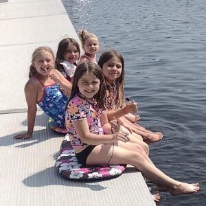 kids sitting on the dock